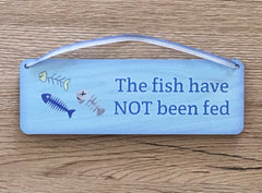 The fish have / have not been fed: double-sided blue sign. Custom-made at www.honeymellow.com